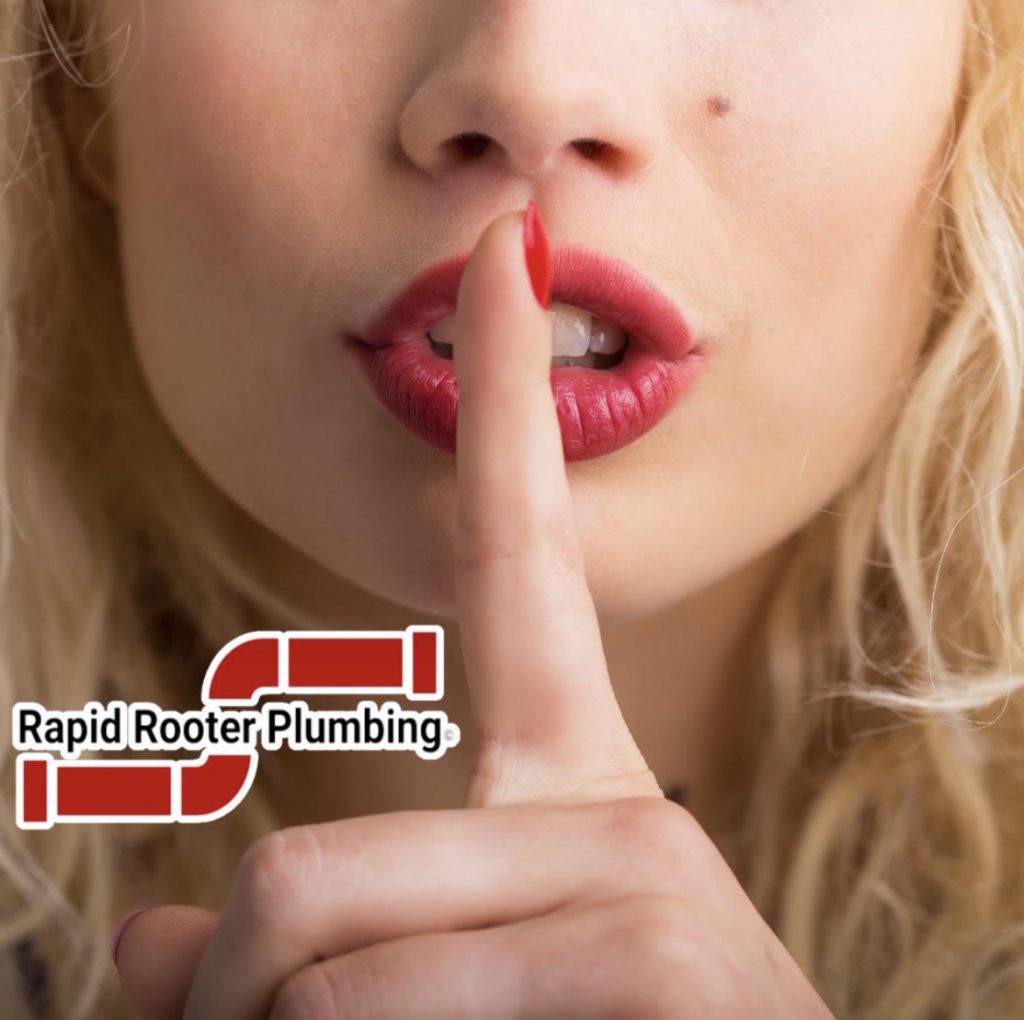 Picture of a woman with her finger covering her mouth in a "shh" position.